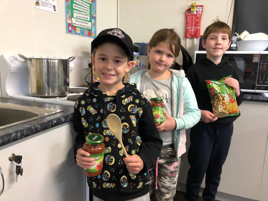 KITCHEN PREP: Lucas Bourke, Ivy Rouget and Nickolas Cashel-Irrgang prepare to whip up some pasta at Leeton Out of School Care this week. Photo: Talia Pattison