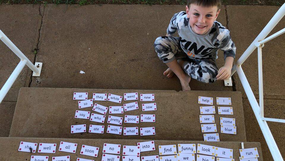 LEARN FROM HOME: Yanco Public School's Tallis Tabain takes his school work outside. Photos: Contributed 