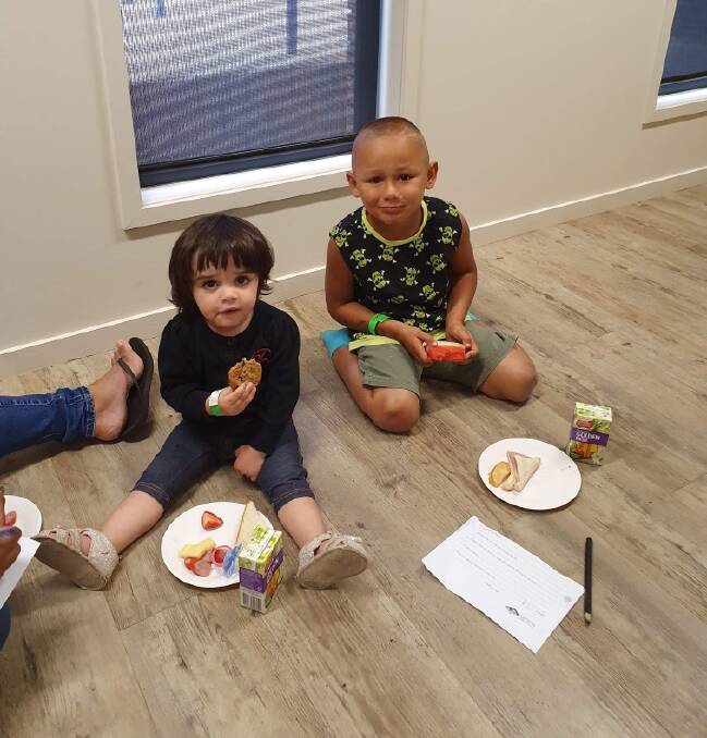 QUICK BITE: Enjoying a snack during the visit to the Leeton library is Miah Wood (left) and Zavier Dimitradis. Photo: Contributed 