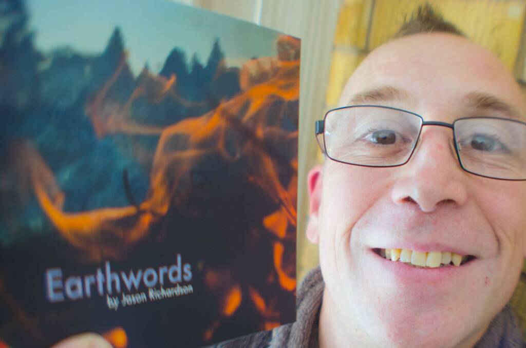 WORK FLOWS: Mr Richardson with his book Earthwords. Photo: Contributed