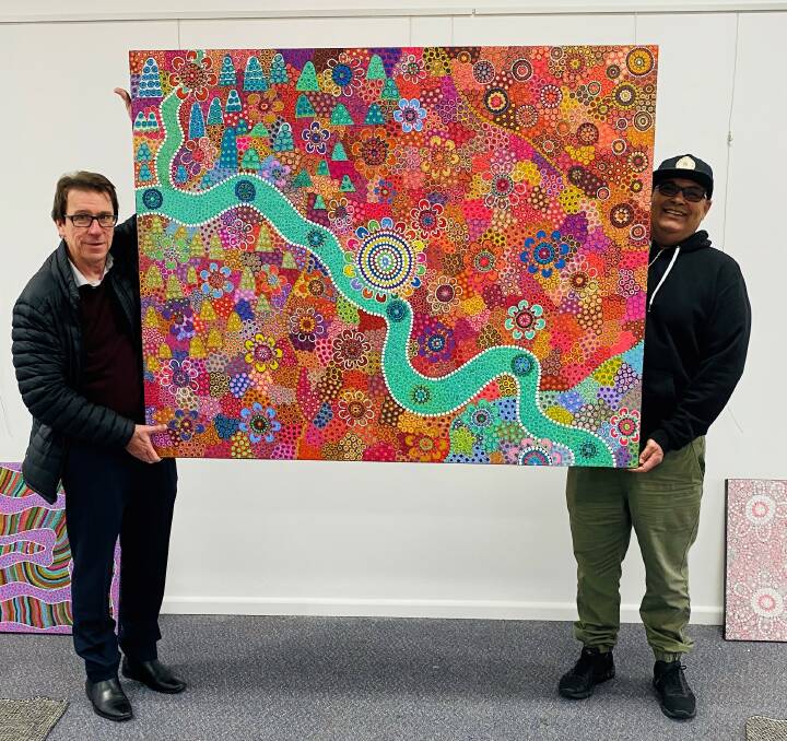 STUNNING: Doctor Joe McGirr (left) with artist Owen Lyons and the commissioned painting. Photo: Contributed 