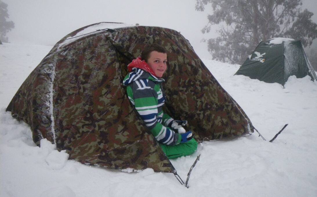 CHILLY CONDITIONS: Ronan Haines and the tent he slept in during a recent trip to the snow with Leeton Scouts. Photo: Contributed