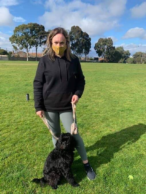 SAFE: Leeton's Paige Frazer with her pooch Zoe during one of their allowed exercise breaks in Melbourne, which is currently under stage four COVID-19 lockdown measures.