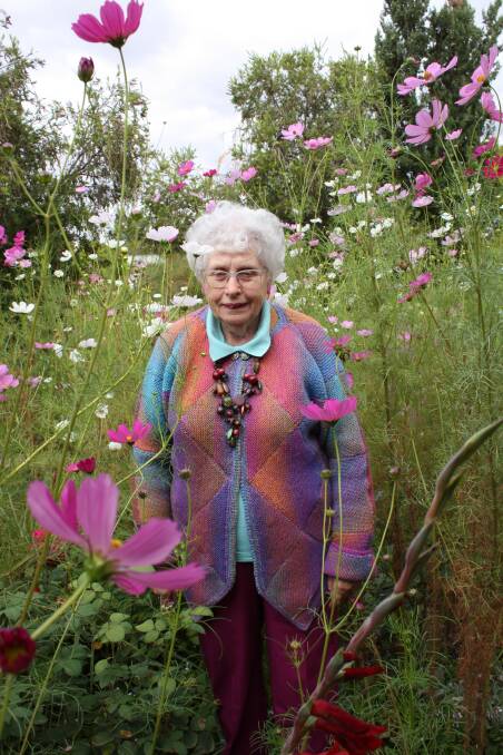 COLOUR: Leeton's Lee Blacker-Noble stands among her cosmos at her garden, which is set to be featured on Easter Monday.