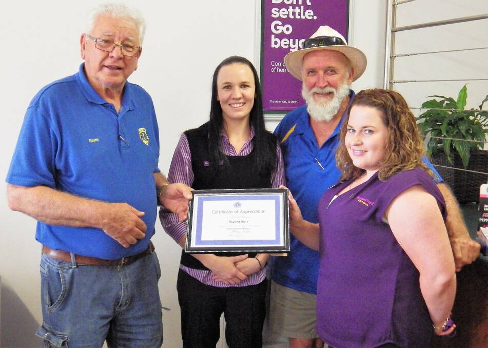 THANKS: District Governor Gavan Ellis (left) presents a certificate of appreciation to
Beyond Bank staff Hannah Williams and Eliza Smith while Col Attree looks on. 