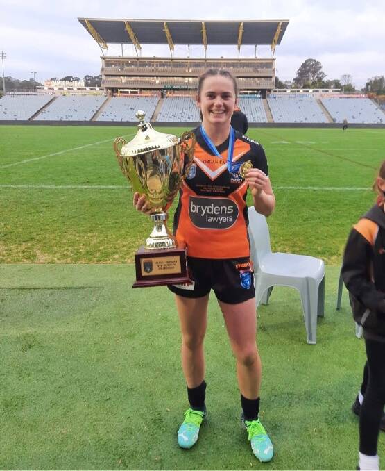 WHAT AN EFFORT: Wests Tigers premiership player, Leeton's Tess Staines with the trophy on Saturday. Photo: Supplied