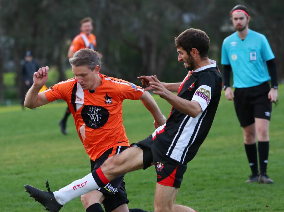 TUSSLE: Leeton United's Pablo Quarin attempts to get to the ball ahead of his Wagga United opponent last weekend. Photo: The Daily Advertiser