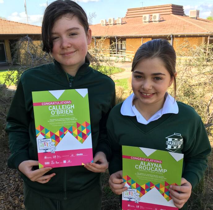 BIG ACHIEVEMENT: Calleigh O’Brien (left) and Alayna Croucamp with their certificates for having their work chosen for the Operation Art exhibition. 