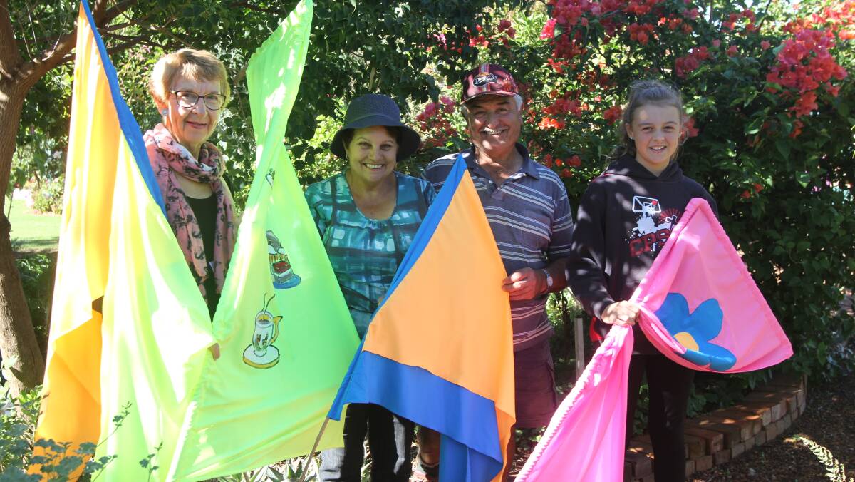 READY: Preparing for the event is Margaret Lang, Zina and Nick Rendina and Sophie Cooper with the new flags that will alert residents to the gardens.