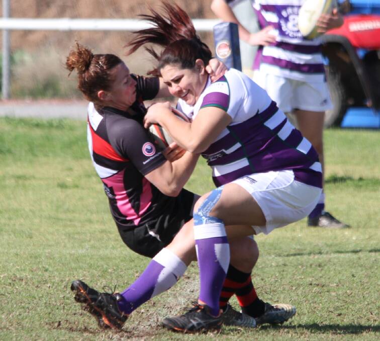 TOUGH CALL: Dianas player Amie Fazekas is brought down by Tumut's Tara Arnall. The Dianas won the match 30-0. Photo: Ron Arel 