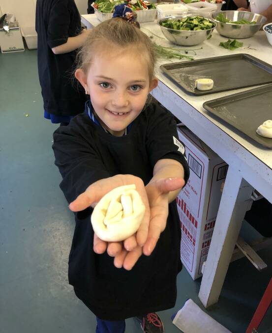 FEAST: Yanco Public School student Aubree Emerson shows off her skills in the kitchen recently during a special visit. Photo: Contributed 