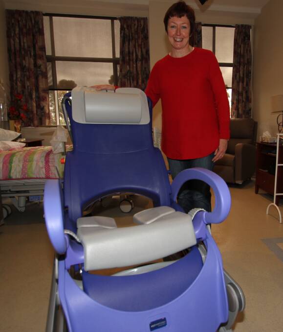 PURCHASE: Leeton Hospital Auxiliary's Leeanne Kidd with one of the new electric shower chairs that has been bought by the organisation. Photo: Ron Arel 