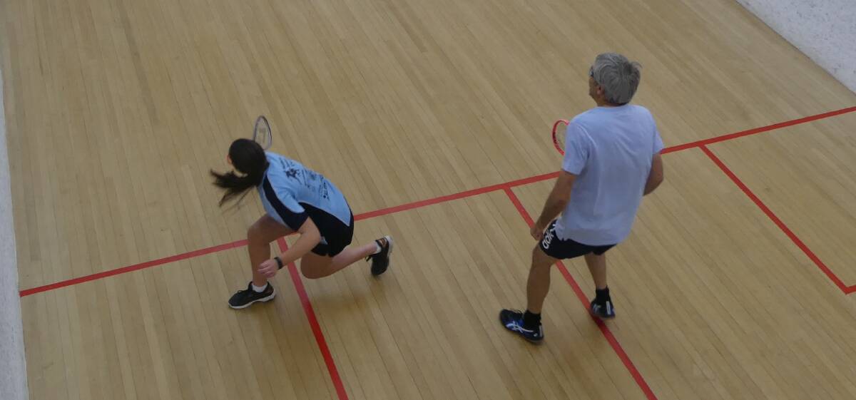 GAME: Alayna Croucamp plays a backhand shot with Garry Walker watching on. Walker went on to win the match. Photo: Supplied