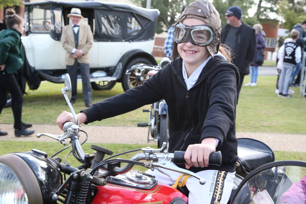 TEST DRIVE: Caitlin Maltman jumps on board a vintage bike during the Chelmsford Place Festival on Saturday. Photos: Anthony Stipo 