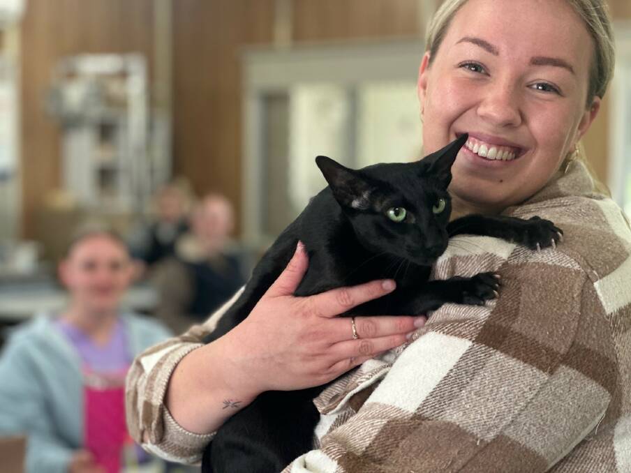 Kasey Aliendi with Misha the cat. Kasey recently won the Certificate IV in Vet Nursing Outstanding Student award at a special TAFE ceremony. Picture supplied 