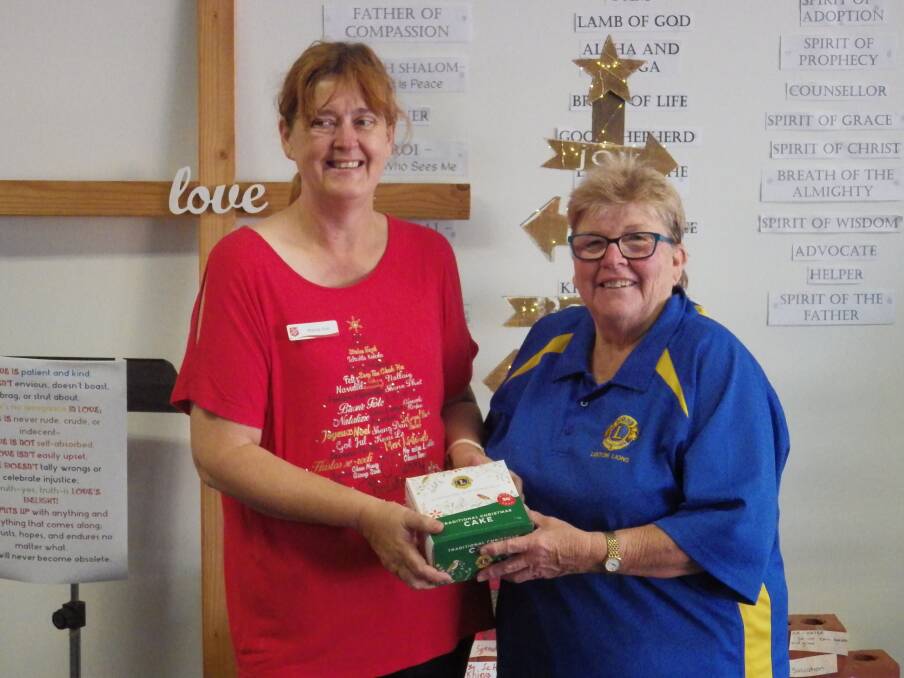 Salvation Army Major Wendy-Sue Swann receiving Lions cakes from Leeton Lions Club's Marie Jackson.