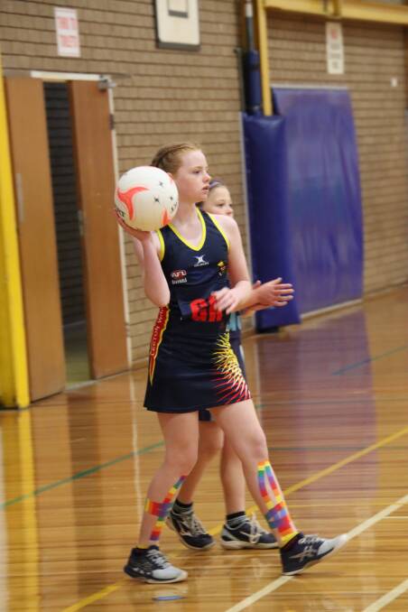 SEARCH: Abigail Blacker passes out of defence during the under 11s grand final. Photo: Travis Irvin 