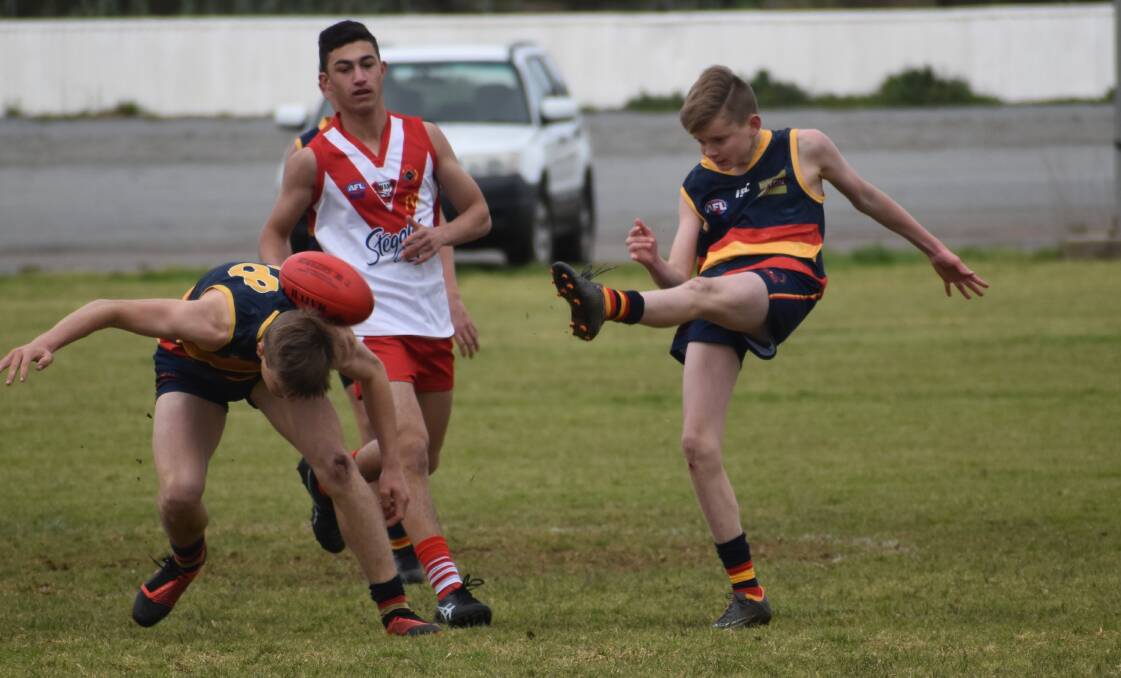 OOPS: Jayden Broadbent boots the ball straight into a Crows under 15s team during an earlier match this season. Photo: Liam Warren