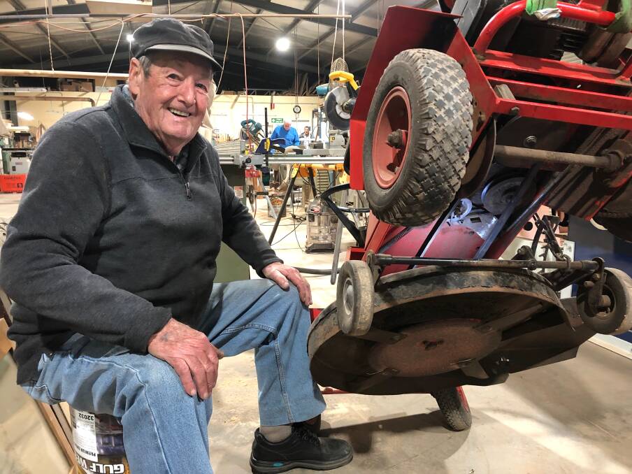 BACK AT IT: Leeton's Men's Shed member John Thurgate has been working to repair this lawnmower. Photo: Talia Pattison