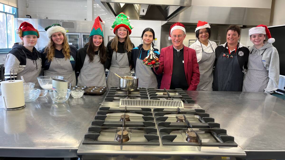 PREP: Leeton High School hospitality students with teacher Lisa Schmetzer and Father Robert Murphy ahead of the Christmas in July events. Photo: Talia Pattison