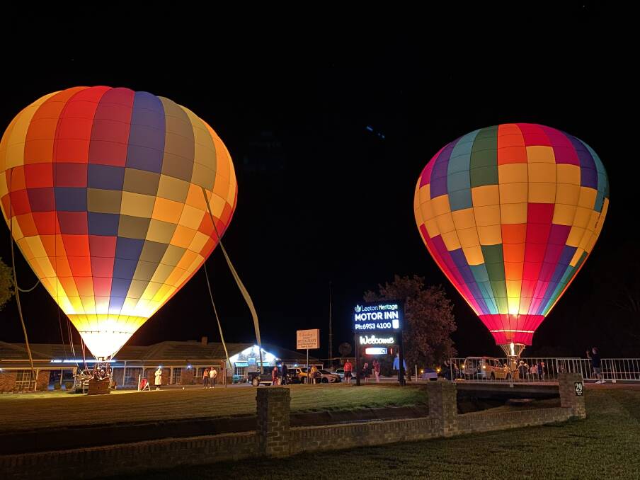 WOW: Balloonists staying at the Leeton Heritage Motor Inn on Easter Sunday spontaneously decided to hold a mini glow at the private venue. Photo: Wayne Bond