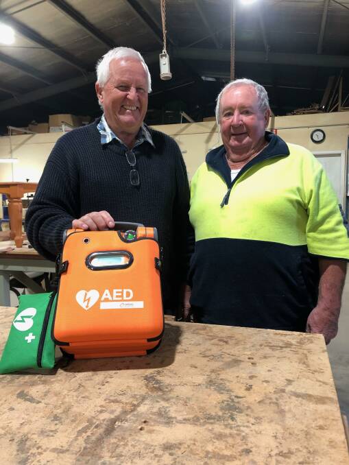 ESSENTIAL: Leeton Men's Shed chairman Ron Hutton (left) and member Mick Smith look over the new defibrillator. Photo: Talia Pattison 