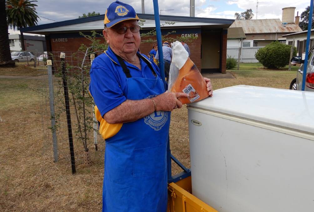 CHRISTMAS FEVER: Yanco Lions Club member Max Preston shows off one of the hams that will be up-for-grabs this weekend. 