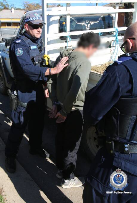 Arrest in progress of one of the men in Narrandera. Photo: NSW Police Force