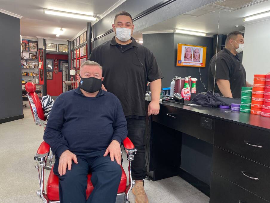 HEARTFELT THANK YOU: Leeton shire's Paul Burley (sitting) with barber Gabriel Adams, who has helped save Mr Burley's life. Photo: Talia Pattison *Note: This image was taken prior to the statewide lockdown. 