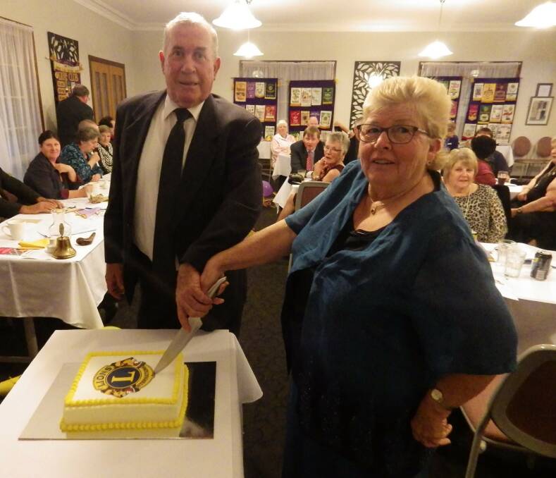 HAPPY: Charter member of Lions Club of Leeton Brian Baldwin and Lion Marie Jackson prepare to cut the anniversary cake. Photo: Contributed 