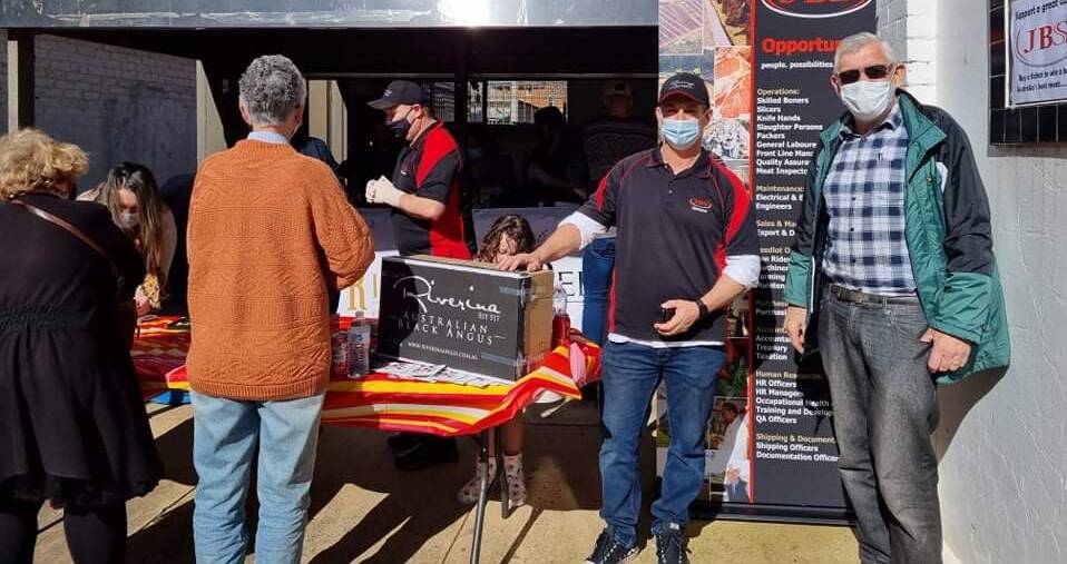 HELP: JBS Riverina plant manager Brett Meads with mayor Paul Maytom at the fundraising stall on Saturday. Photo: Supplied