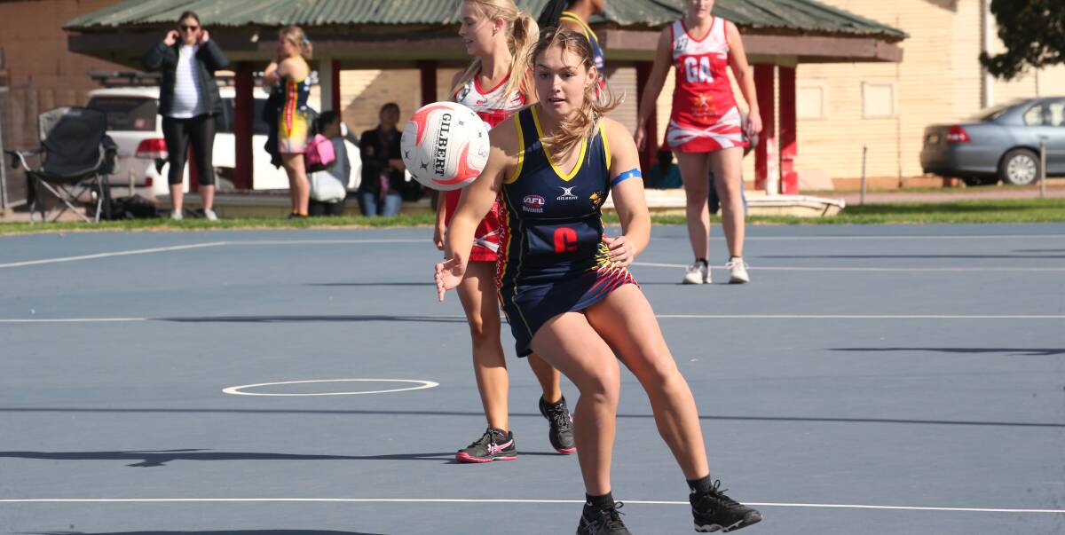 FOCUS: Tyler McKellar readies herself to pick up a loose ball during the Crows A grade netball game on Saturday. Photo: Anthony Stipo 
