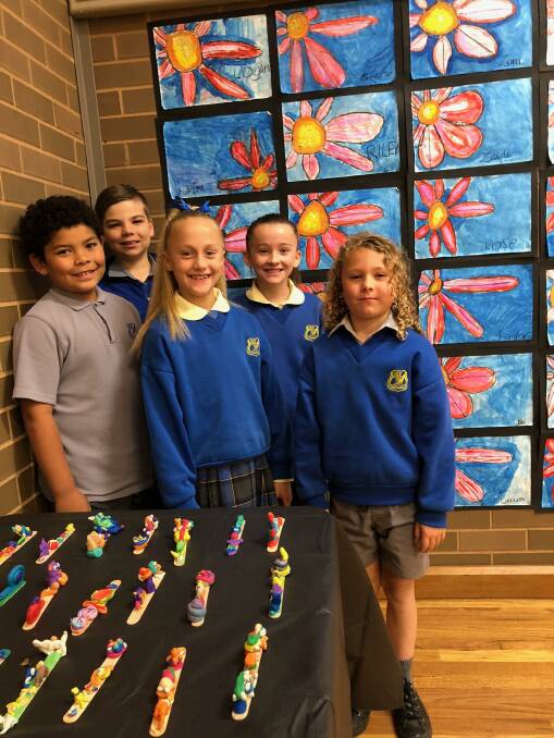 COLOUR: Students (back) Wesley Wate, Zaide Harmer, (middle) Sage Deaton, Edi Ryan and (front) Kade McLennan display some of the bright work on display. Photo; Talia Pattison