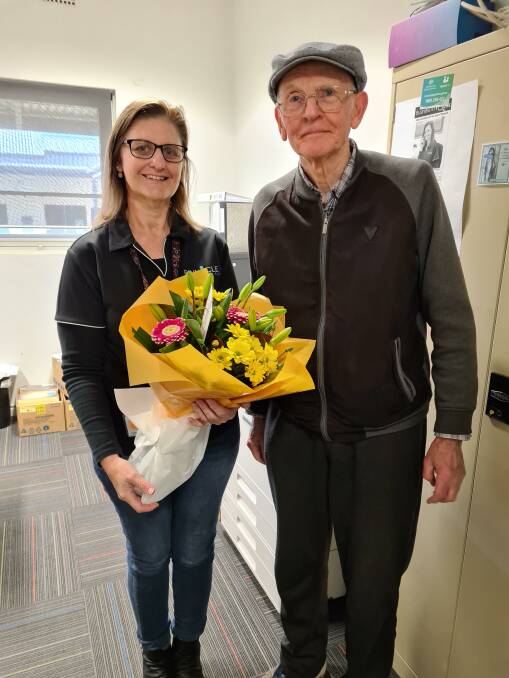 GIFT: Fredrick Ifield presents co-ordinator Tanya Lewis with some beautiful flowers to say thank you for her hard work. Photo: Contributed 