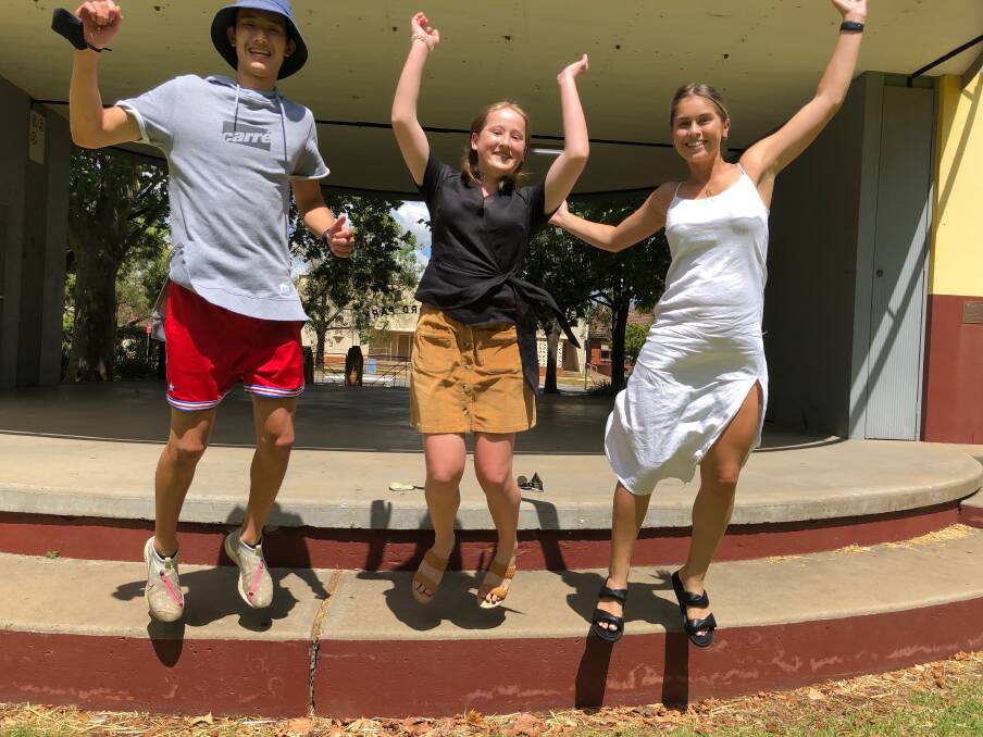 JUMP FOR JOY: Jay Tang, Elizabeth Smith and Georgia Robinson celebrate their excellent HSC results after completing year 12 at St Francis College. Photo: Talia Pattison