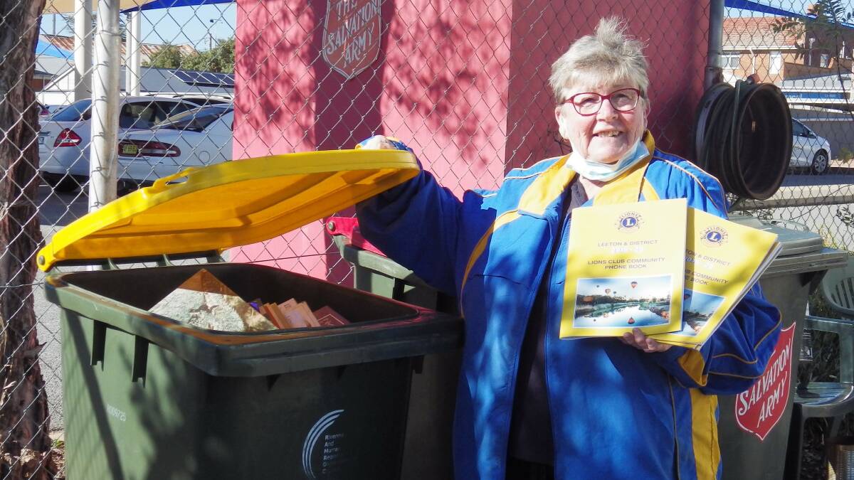 OUT WITH THE OLD: Lions Club of Leeton president Marie Jackson prepares to recycle the old phone books to make way for the new ones. Photo: Supplied