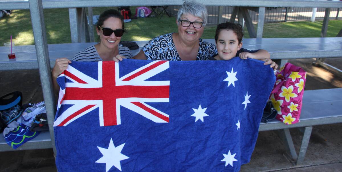 SPLASHING GOOD FUN: Nadia Gerhardy, Vita Vitelli and Toby Kelly, 5, share their Aussie pride at the Australia Day pool party. Photo: Ron Arel