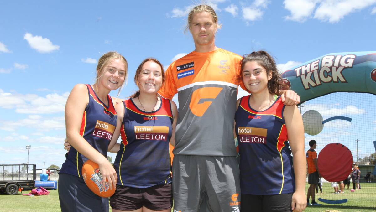 YOUNG GUNS: Seaena Penfold, 15, Eilish Morden, 14, and Laura Ianelli, 15, meet Harry Himmelberg from the Giants. This year marks the first time an under-16s girls' Aussie rules competition will be held in the MIA. Photo: Ron Arel 
