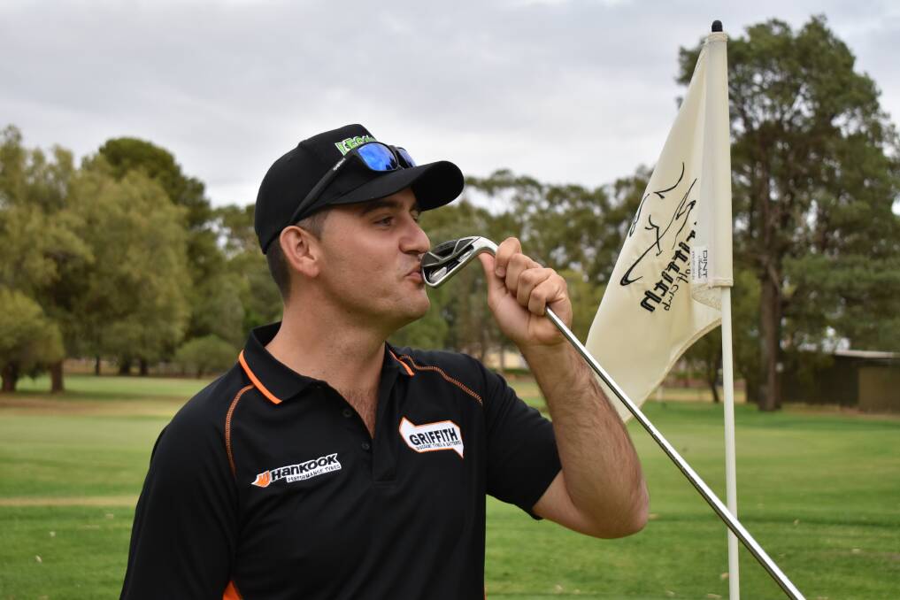 GREAT DAY OUT: Joel Undy kisses the six-iron he used to hit a hole-in-one at Griffith Golf Course. PHOTO: Shaun Paterson