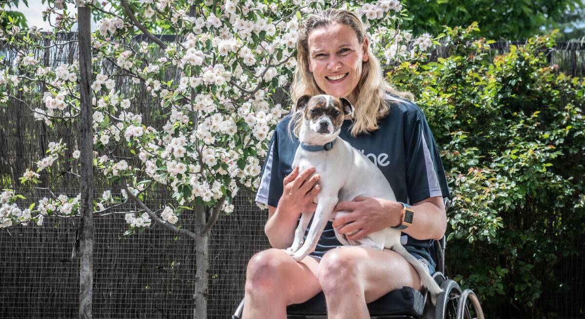 Lifeline Australia custodian and paralympic shot putter, Louise Ellery with her dog Oogi. Picture: Karleen Minney