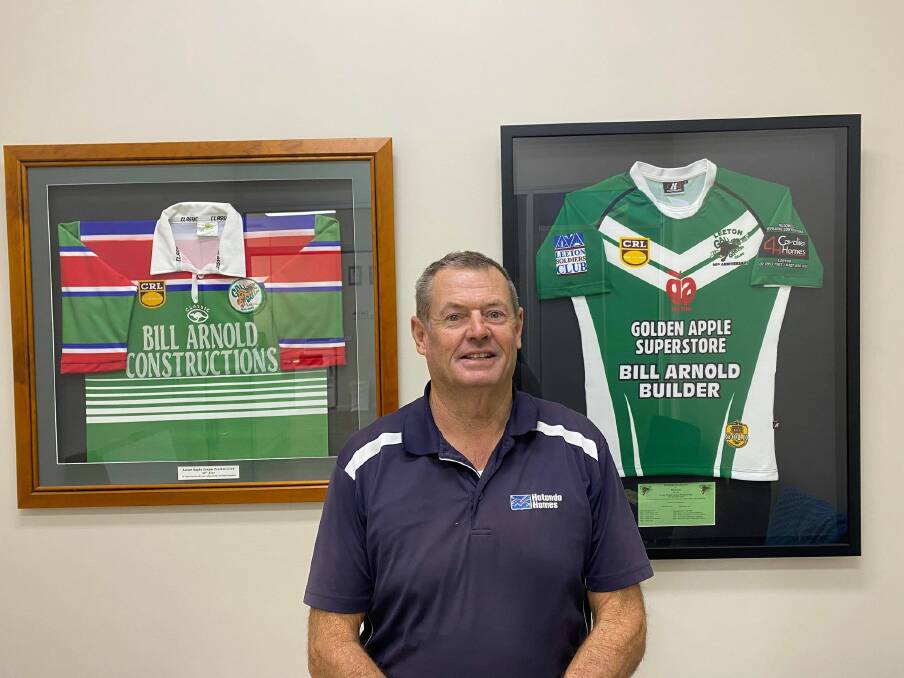 Ready to celebrate: Bill Arnold with two of the memorabilia jerseys that will be on display at the reunion celebration. Photo: Elizabeth Gracie 