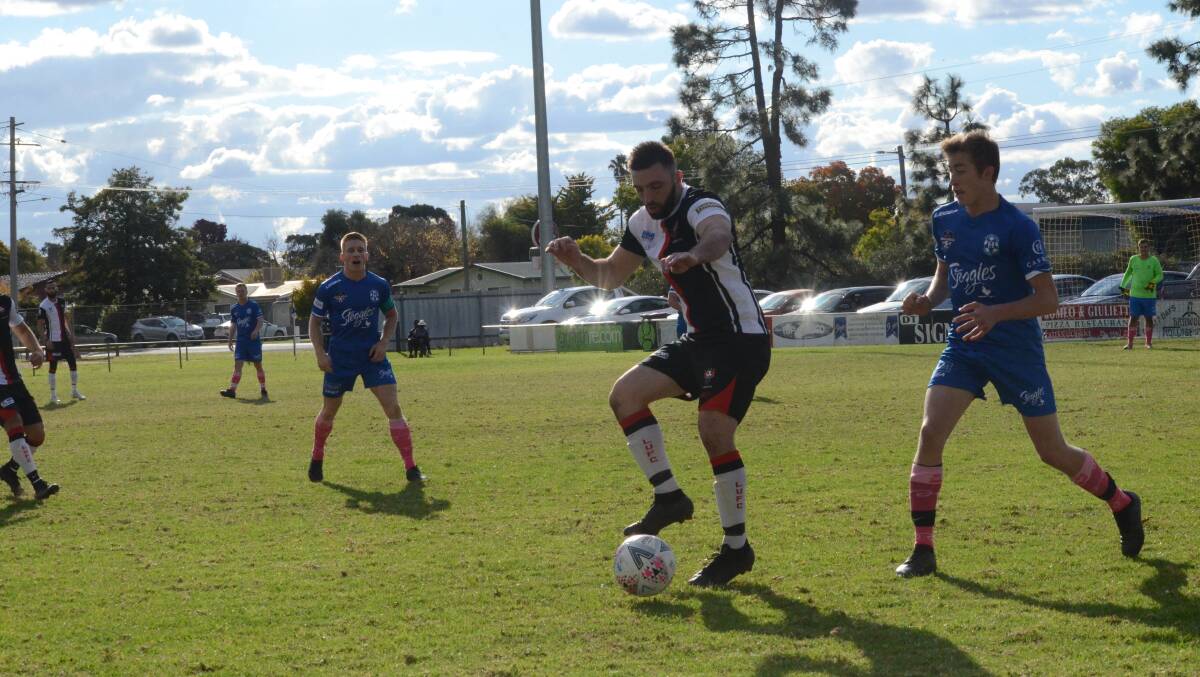 STRUGGLE: Adam Raso on the ball as Leeton fought for a way back into the game against Hanwood. PHOTO: Monty Jacka