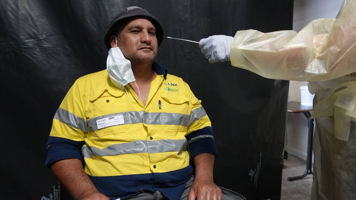 BETTER SAFE THAN SORRY: Interstate truck driver Eddie Ihaka getting his COVID-19 swab test at the Griffith testing centre on Yambil Street. PHOTO: Monty Jacka