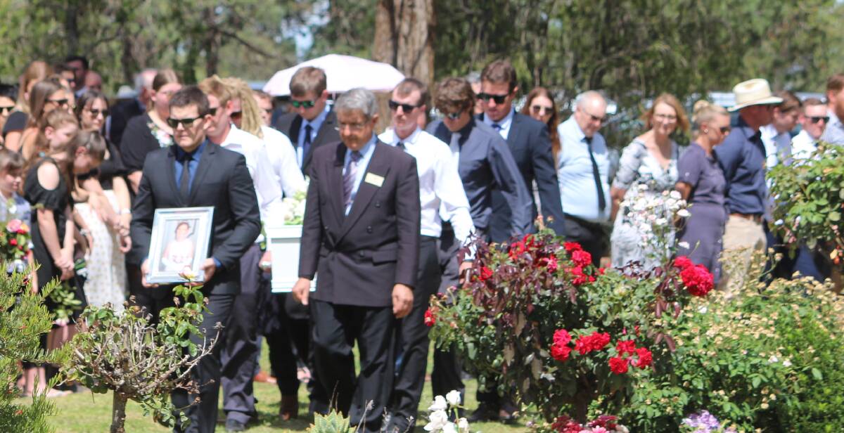 FAREWELLED: Ella Painting's coffin is carried following a guard of honour. PHOTO: Calhan Behrendt