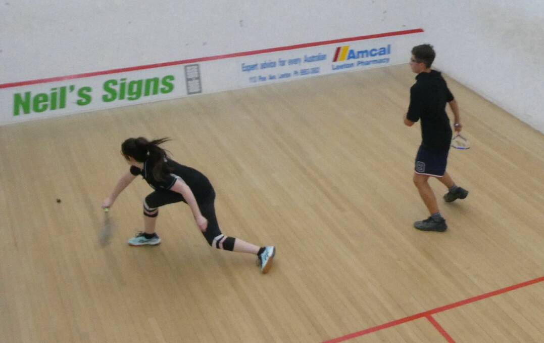 REACHING: Brianna Gray-Mills stretches to return a shot from Brodie Lashbrook in Leeton squash action. Picture: SUPPLIED