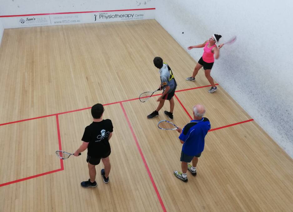 DOUBLES: Emily Lyons serves the ball with Blayne Thompson (black shirt) ready to receive as Bryan Shepley (blue shirt) and Will Rawle watch on during the second round of the squash competition at Leeton Soldiers Club.