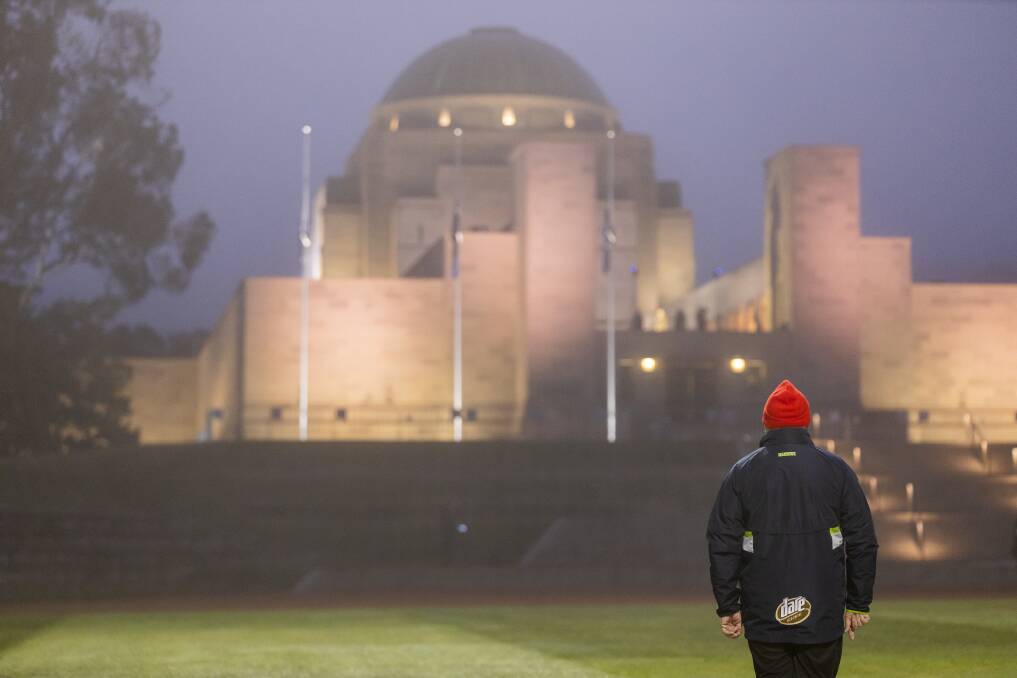A man silently observing the Anzac Day dawn service at the Australian War Memorial at the height of COVID lockdowns. Picture: Sitthixay Ditthavong
