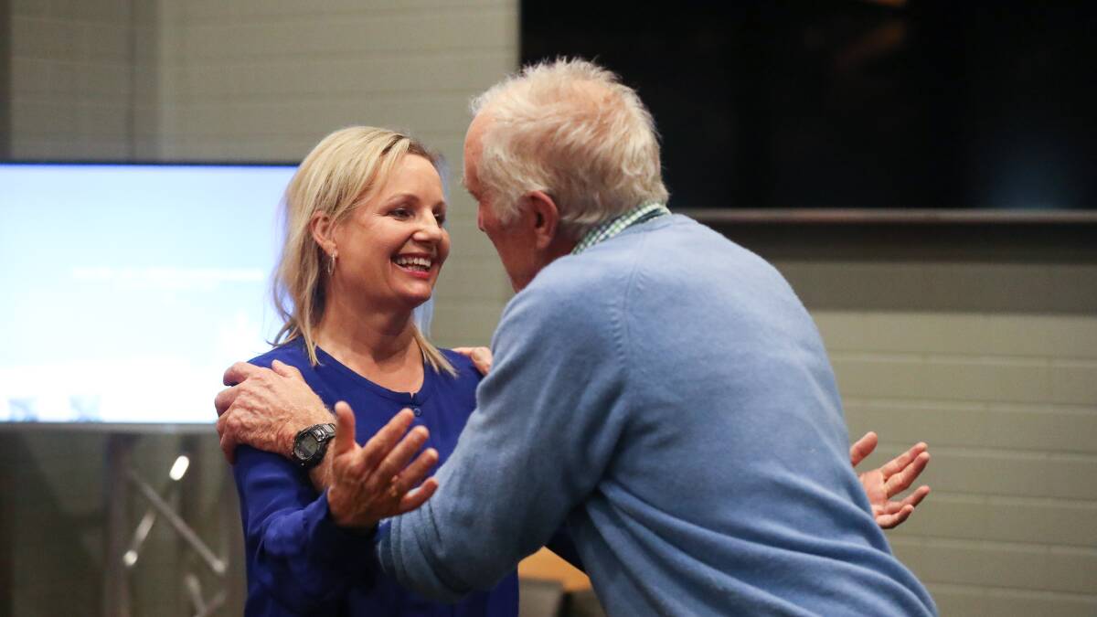 SWEET VICTORY: Liberal MP Sussan Ley is congratulated by her long-time campaign manager Angus Macneil on Saturday night. PHOTO: Mark Jesser
