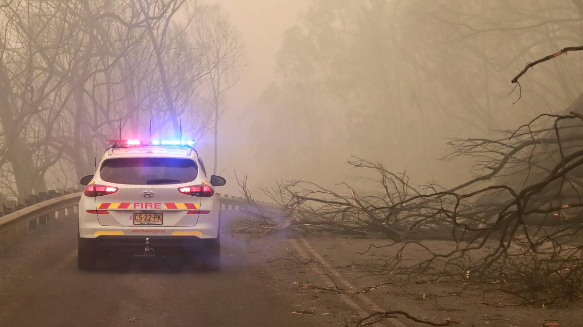 DUNNS ROAD FIRE: Emergency vehicles comb through the aftermath of fires between Wondalga and Batlow at the start of the year. Picture: Les Smith