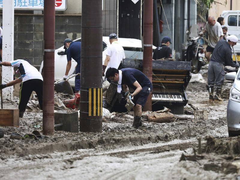 At least 20 people are dead after torrential rain triggered landslides and flooding in Japan.